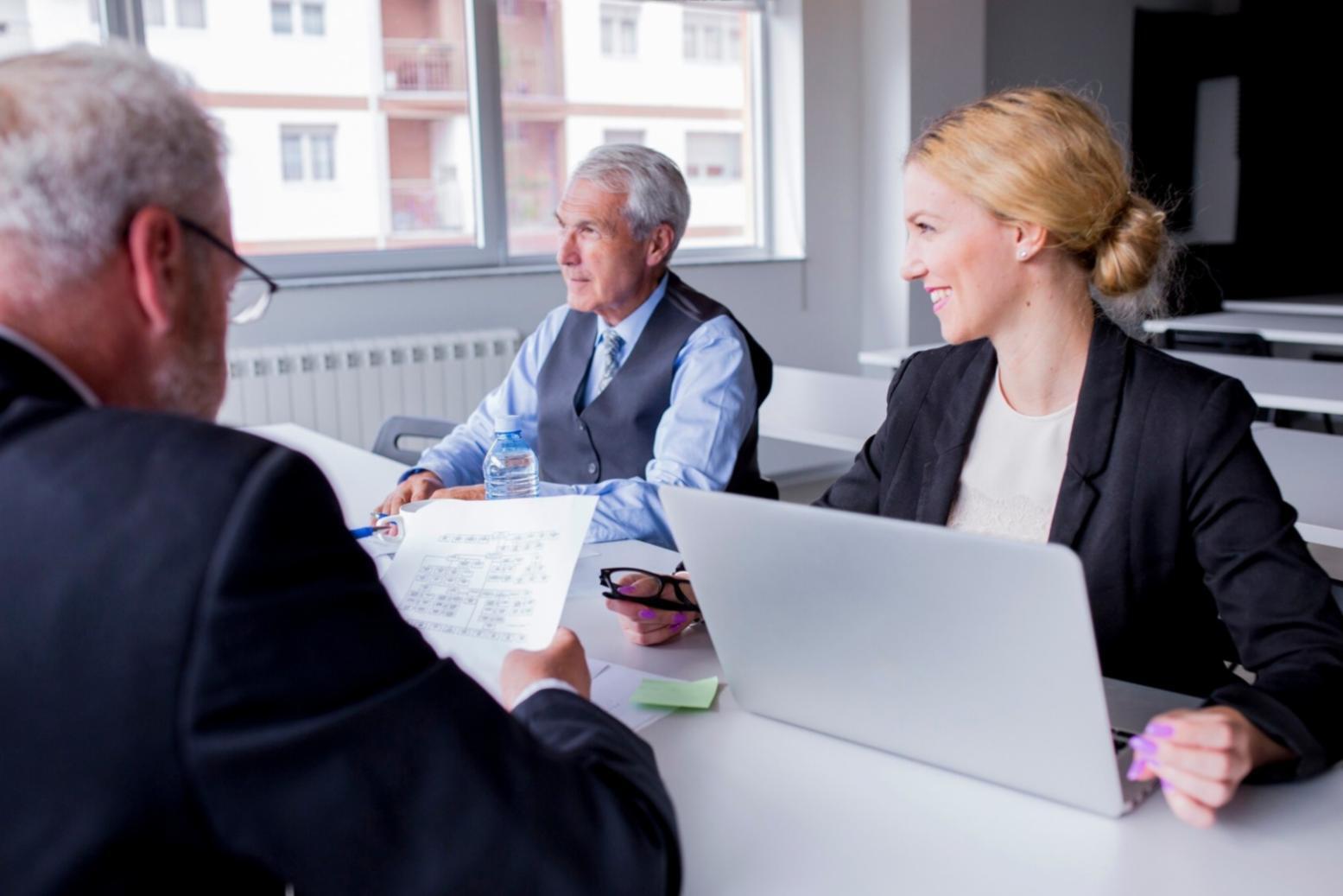 Small business owners reviewing financial documents and planning budgets
